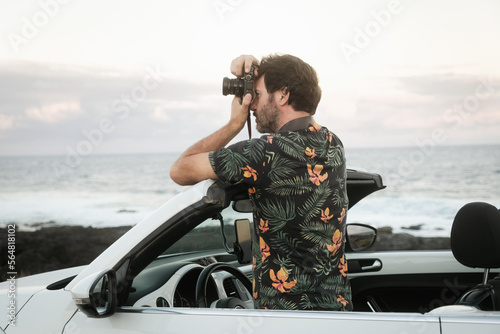 Man taking photo from inside a car photo