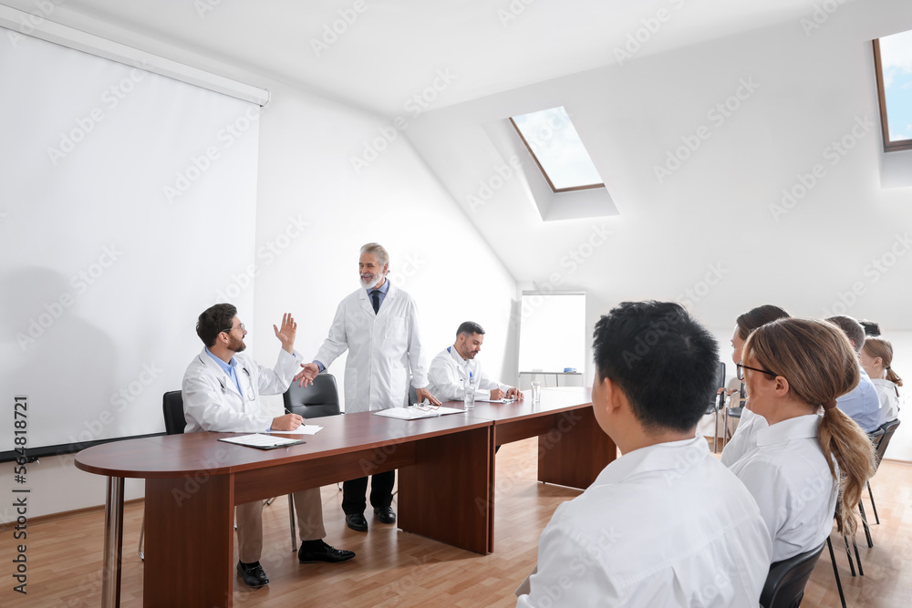 Doctors having discussion on lecture during medical conference Doctors having discussion on lecture during medical conference