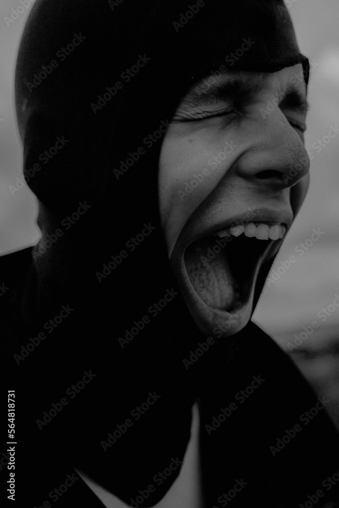 Artistic and expressional portrait of a young man screaming Artistic and expressional portrait of a young man screaming