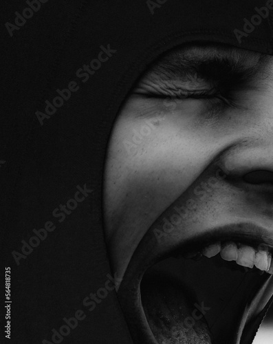 Artistic and expressional portrait of a young man screaming photo
