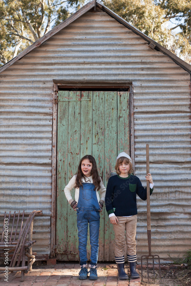 Kids in front of old shed Kids in front of old shed