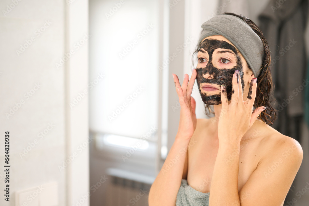 Woman apply mask with both hands. Woman apply mask with both hands.