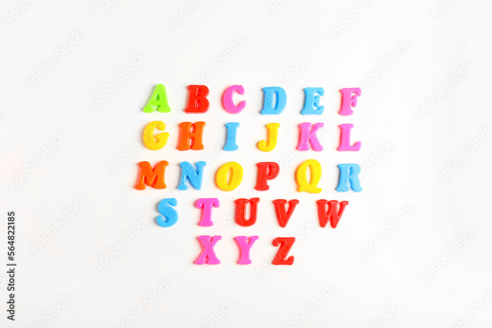 Colorful magnetic letters on white background, flat lay. Alphabetical order Colorful magnetic letters on white background, flat lay. Alphabetical order
