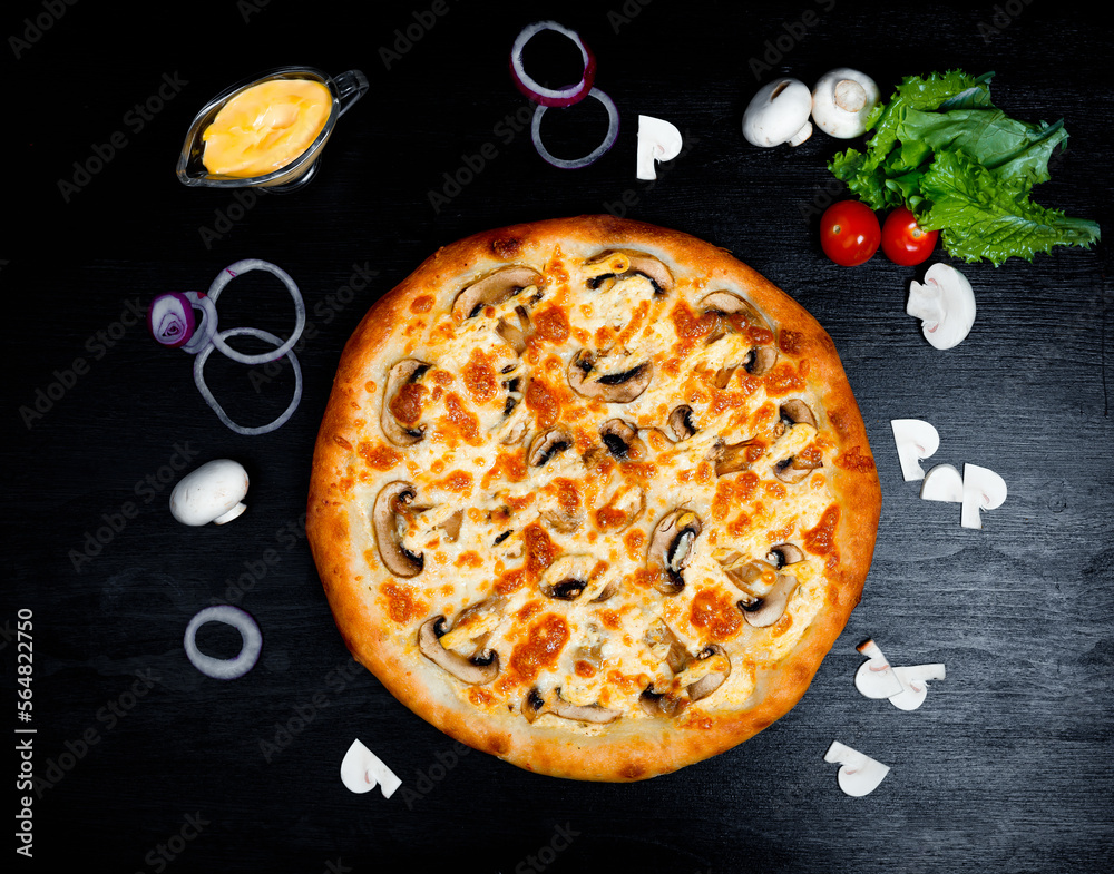 Italian pizza with mushrooms, cheese, tomato, onion a ,black table, side view