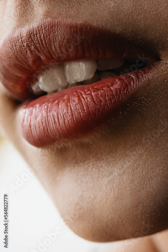 Close-up sensual woman's big plump red lips of anonymous woman 