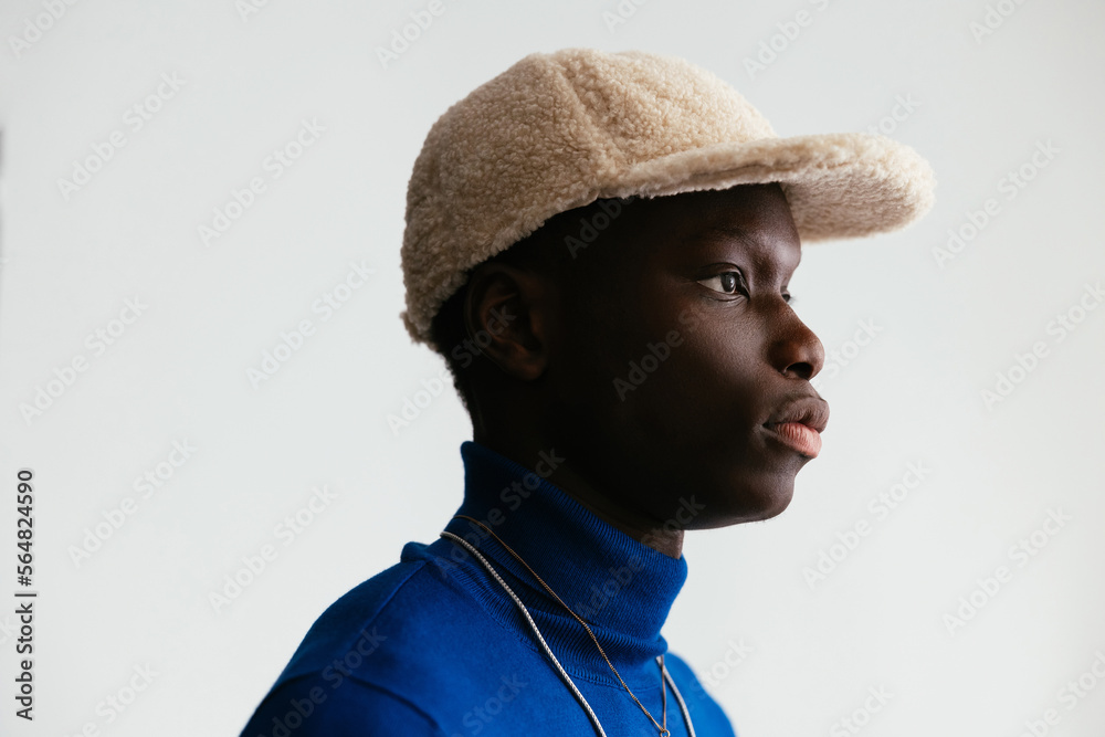 Calm black man in fluffy cap Calm black man in fluffy cap