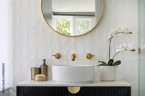 Bathroom with circular hand basin and brass tap ware photo