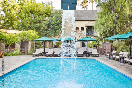 Water fountain in pool at luxury hotel photo