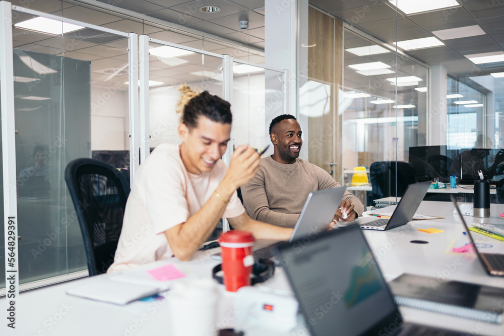 Business people working in a coworking office with laptop Business people working in a coworking office with laptop