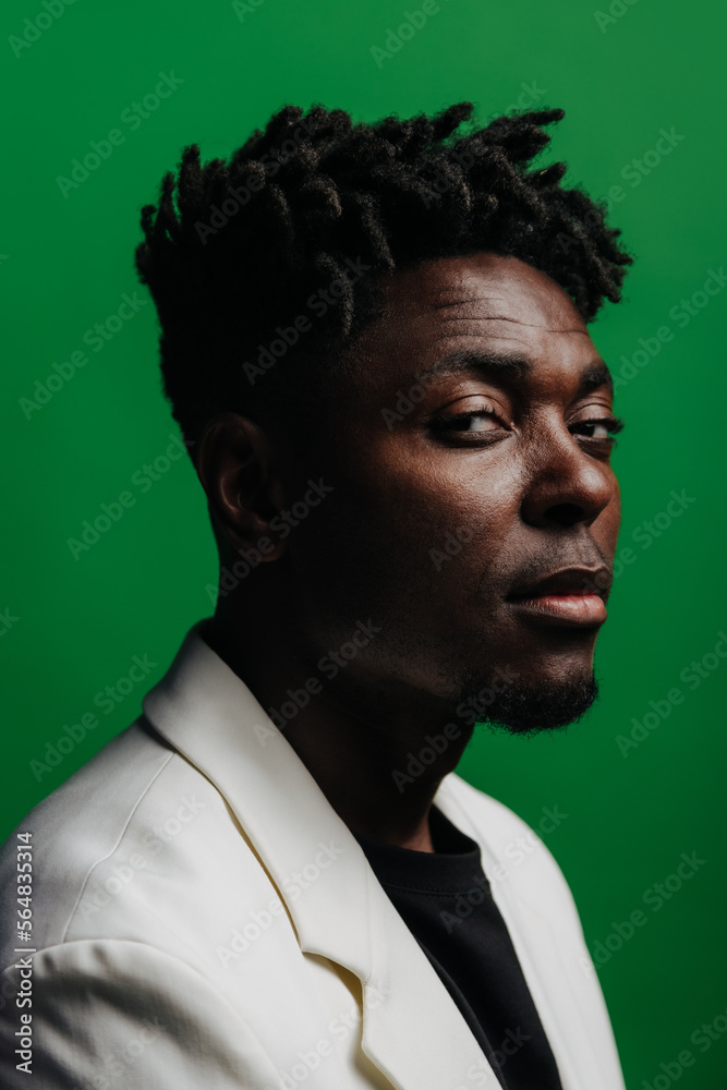 © VICTOR TORRES/Stocksy - Portrait of serious black man with dreadlocks