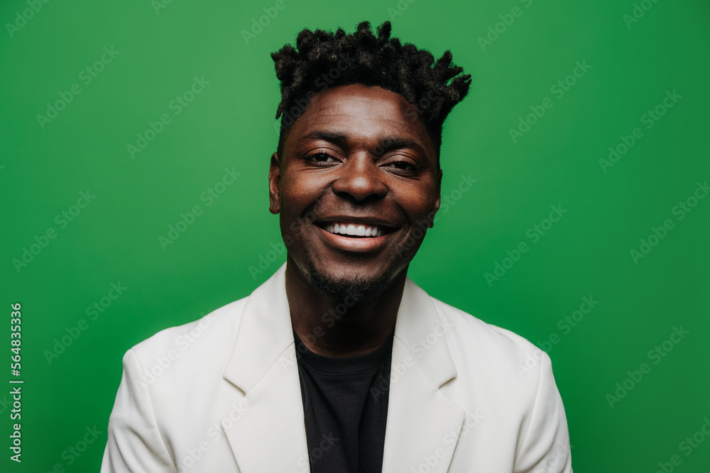 Portrait of cheerful black man in white jacket looking at camera Portrait of cheerful black man in white jacket looking at camera