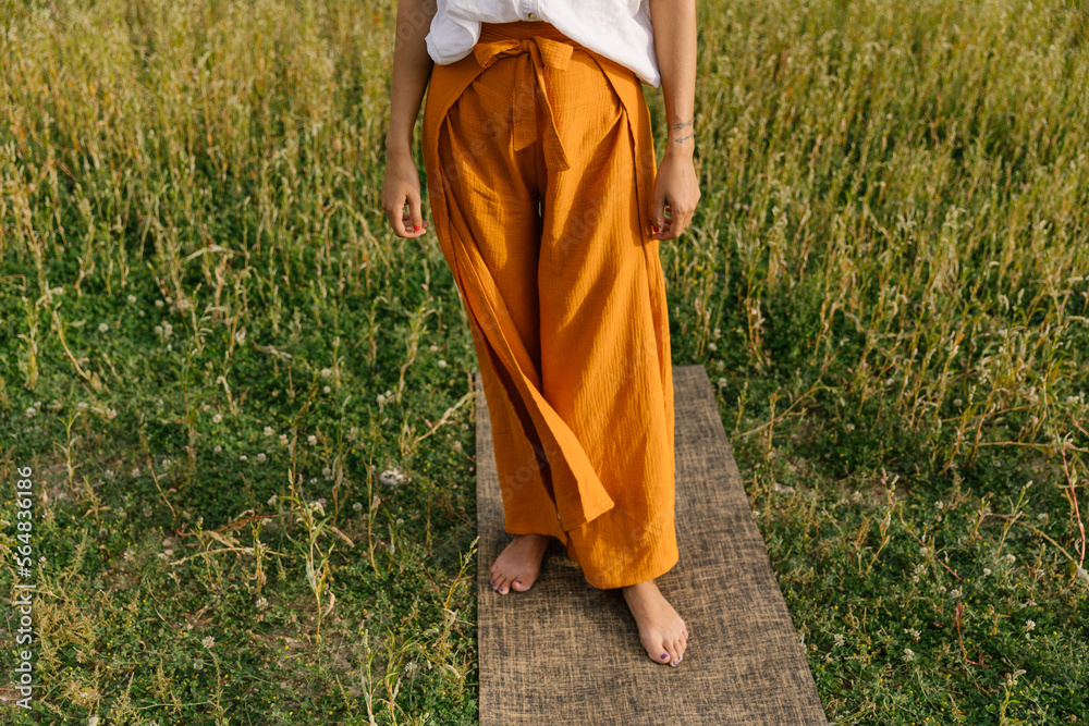 Anonymous Woman Standing On The Yoga Mat Anonymous Woman Standing On The Yoga Mat