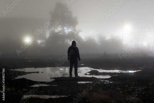 A man on a foggy night photo