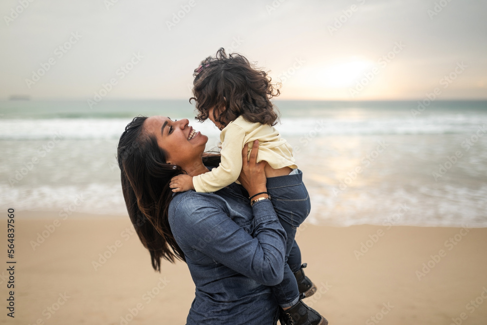 mother with baby on the beach in autumn mother with baby on the beach in autumn