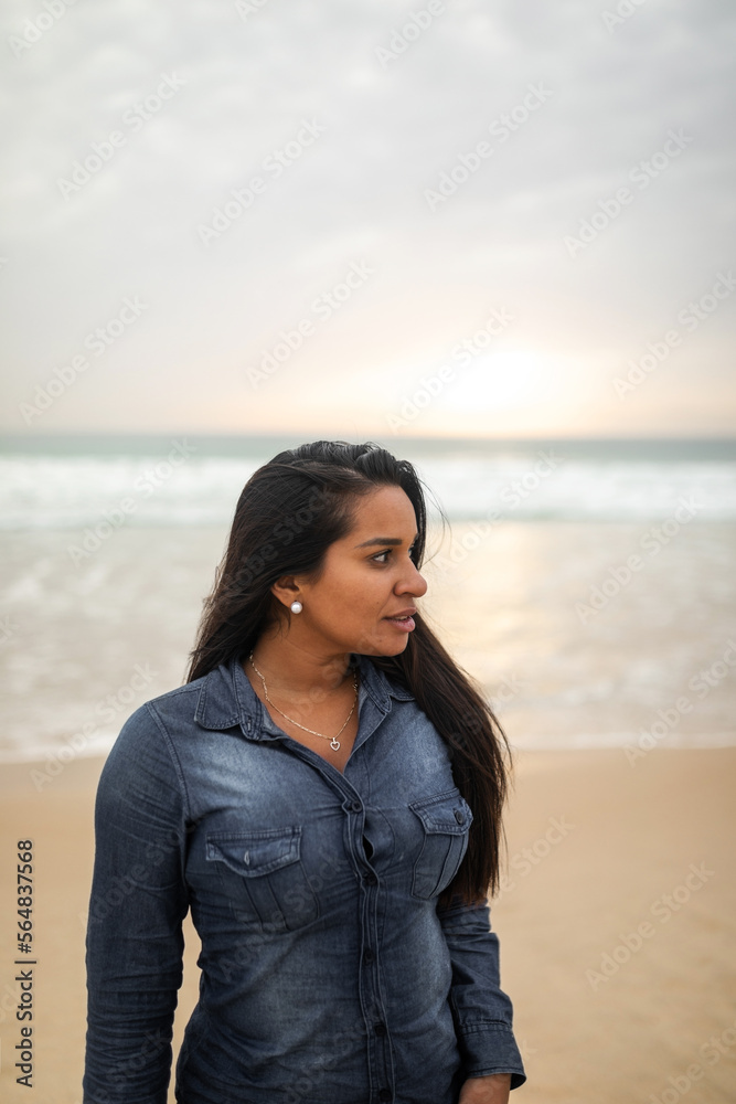 latin young woman on the beach in autumn latin young woman on the beach in autumn