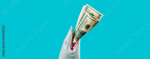 shark biting some fake dollars, banner format photo