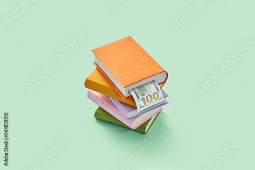 Paper stack of books with sticking out dollar.