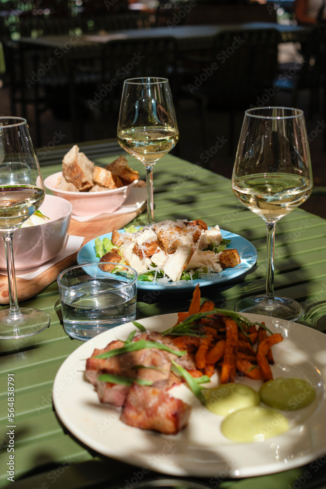 Caesar salad, steak and wine. Caesar salad, steak and wine.