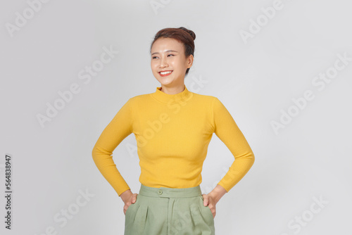 Happy young woman in a turtleneck shirt and shorts is posing photo