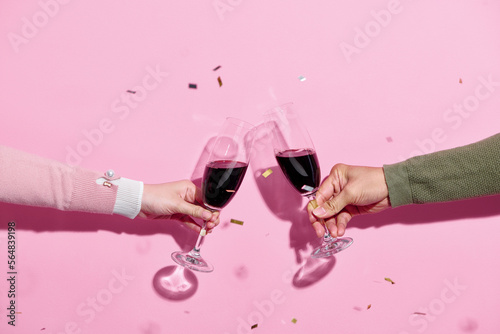 Celebration toast with wine with color streamers photo