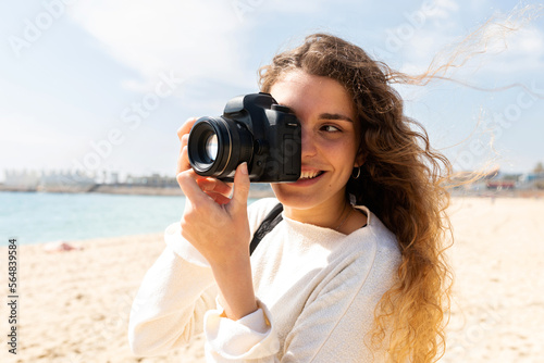 Woman taking pics by the beach