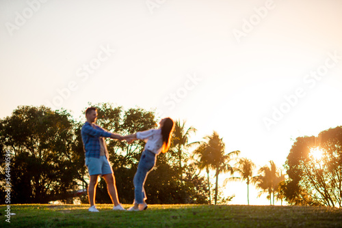Family of two in the park on summer day outdoors at sunset light