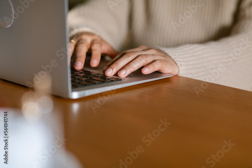 Female hands typing on laptop closeup photo