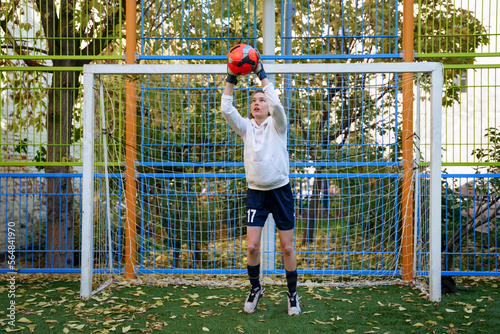 Female soccer player goalkeeper trains on the sports field