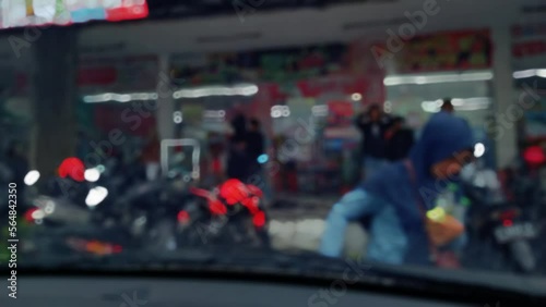 Wallpaper Mural Defocus, Out of Focus view of A group of random people, traveler take shelter for the heavy rain in front of convenience store, scene taken from inside car Torontodigital.ca