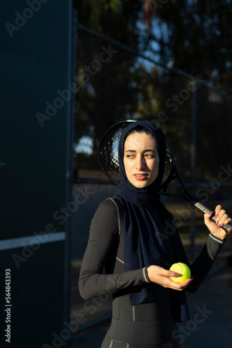 Sunrise tennis portrait in hijab photo