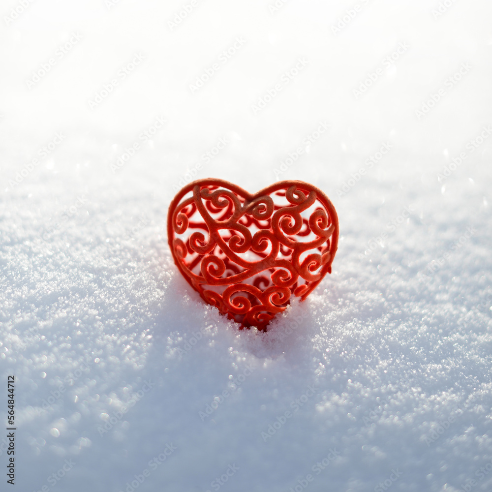 Red Valentine in white snow. Red frozen heart on snowy background. Valentines day card, February 14