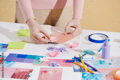 Lifestyle photography of a female art director hands arranging a set photo