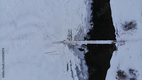 Icy River in Winter Look down Aerial Footage photo