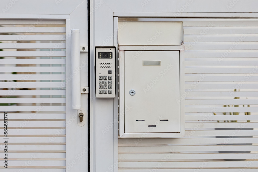 Modern intercom on white door Modern intercom on white door