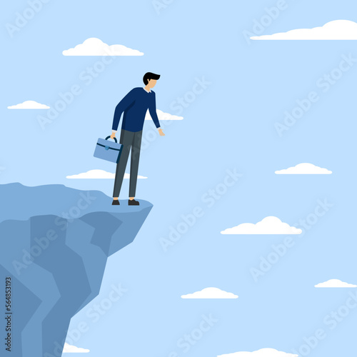 Investment or financial risk of falling down from economic recession, fear of losing money or repaying debt concept, businessman standing on edge of cliff in sky looking down with fear of heights.