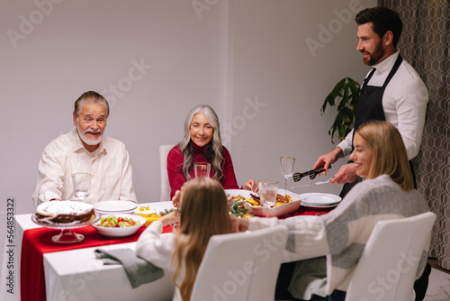 Happy at home. Christmas eve. Joyful emotions. Adorned dining table photo