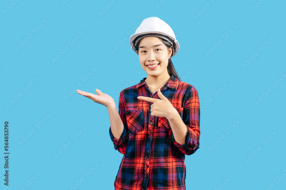 Young asian engineer female standing with open palm posture Young asian engineer female standing with open palm posture