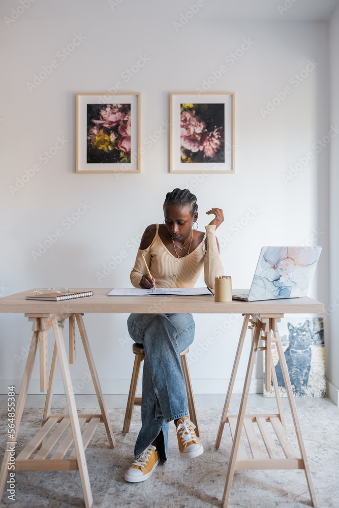 Female architect working in home office Female architect working in home office