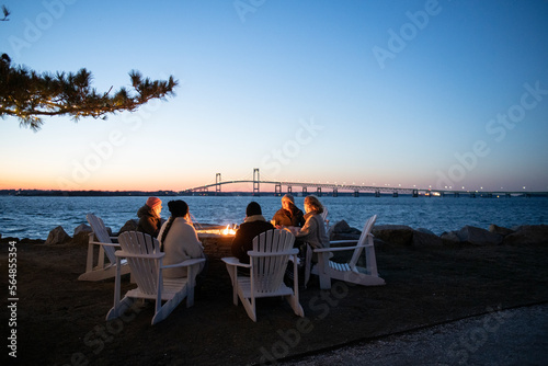A group of women enjoying wine by the fire in Winter