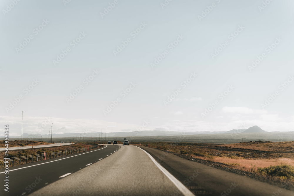 Empty Road Into The Horizon. Mountains and open sky on background Empty Road Into The Horizon. Mountains and open sky on background