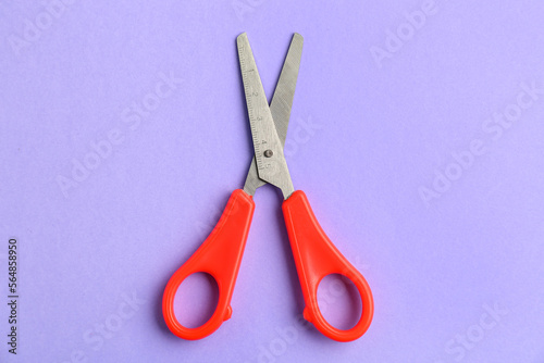 Red scissors on lilac backg...