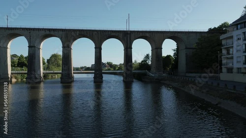 Drone flying over the Mayenne Laval River, France. Arches of the railway bridge photo