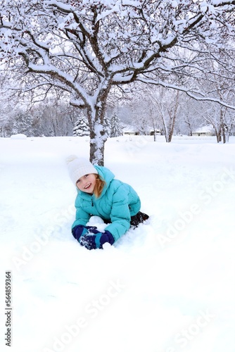 girl playing in snow