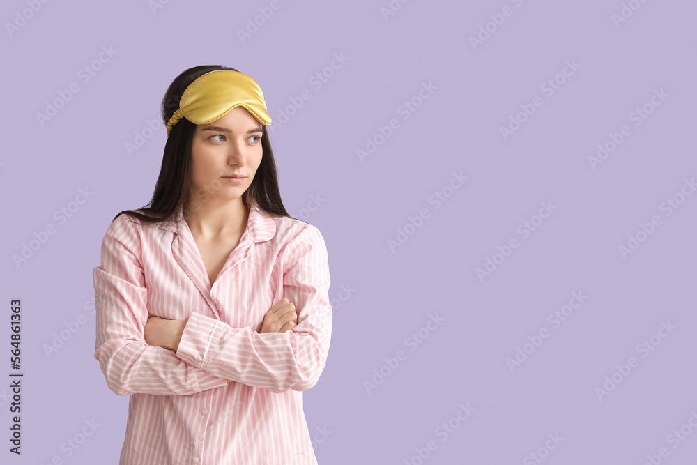 Young woman with sleeping mask on lilac background Young woman with sleeping mask on lilac background
