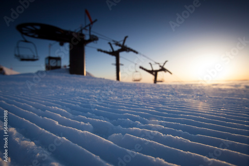 Silhouette of a chairlift at sunrise.