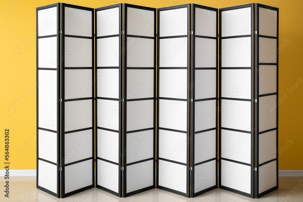 Folding screen near yellow wall Folding screen near yellow wall