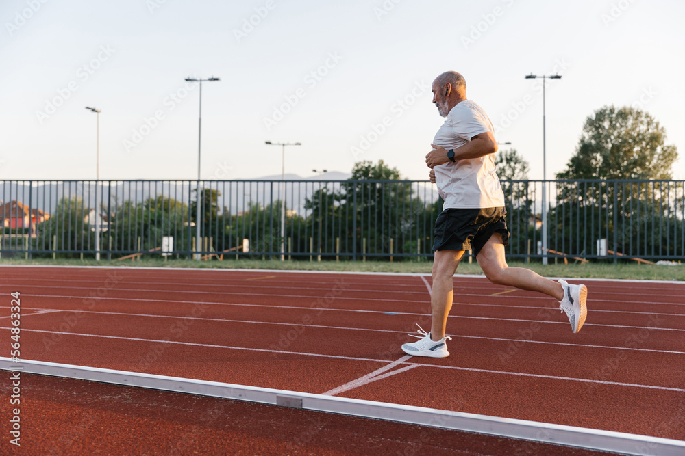 Boomer Athlete Having A Cardio Training On A Track Boomer Athlete Having A Cardio Training On A Track