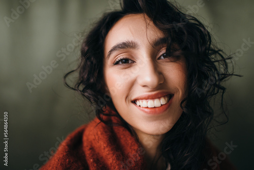 Closeup happy woman portrait with curly hair photo