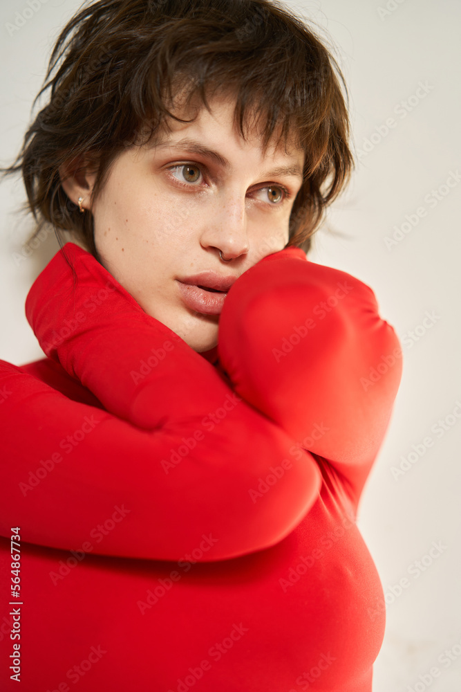 Sad young woman touching neck Sad young woman touching neck