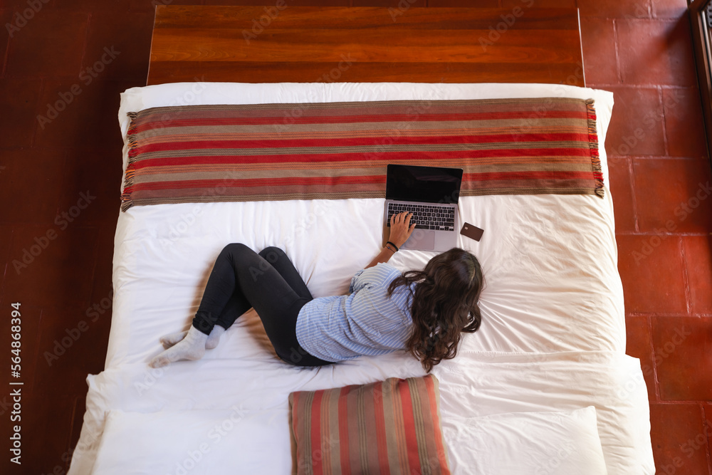 woman lying on bed with her laptop Stock Photo | Adobe Stock
